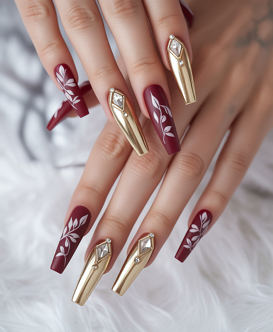 coffin nail designs 2026 Burgundy Coffin Nails With Gold Sculptural Accents