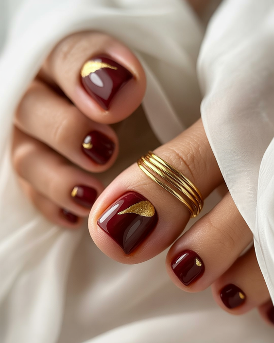 cute toe nail colors 2026 Deep Burgundy With Gold Crescent Accents