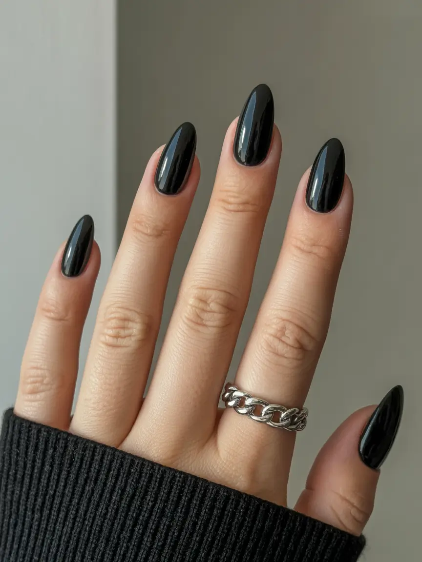 gel nail designs 2026 High gloss black almond nails with a modern edge